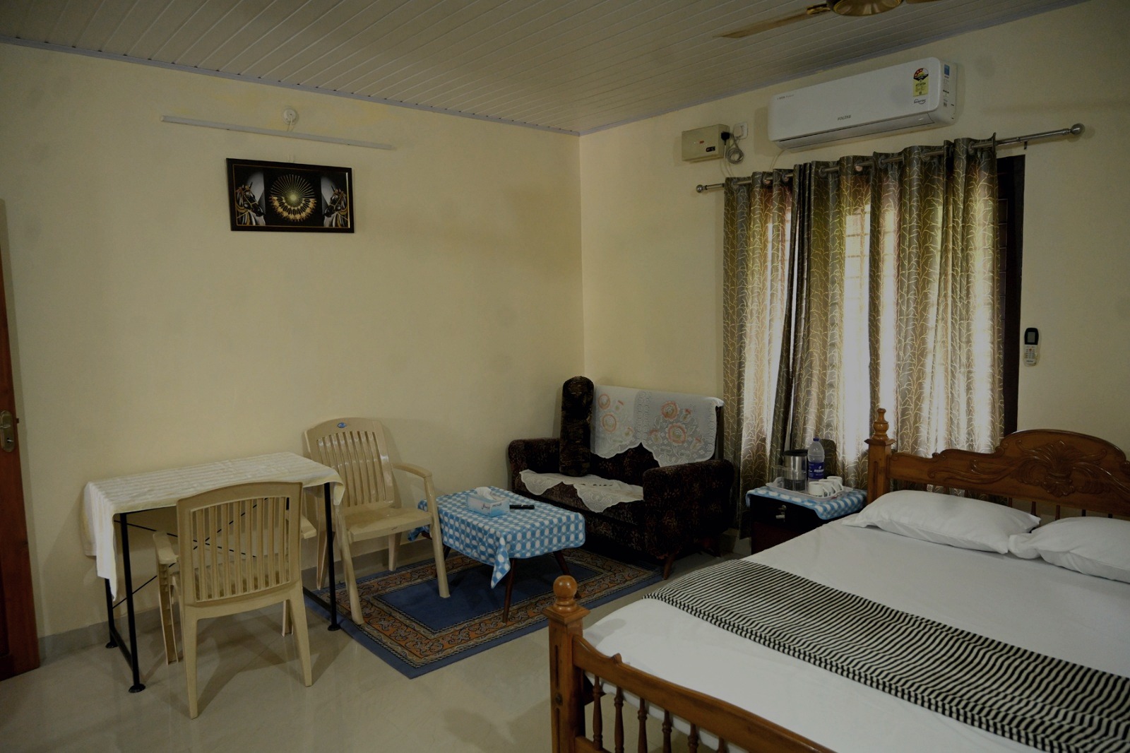 Bedroom with queen bed, sofa and air conditioning